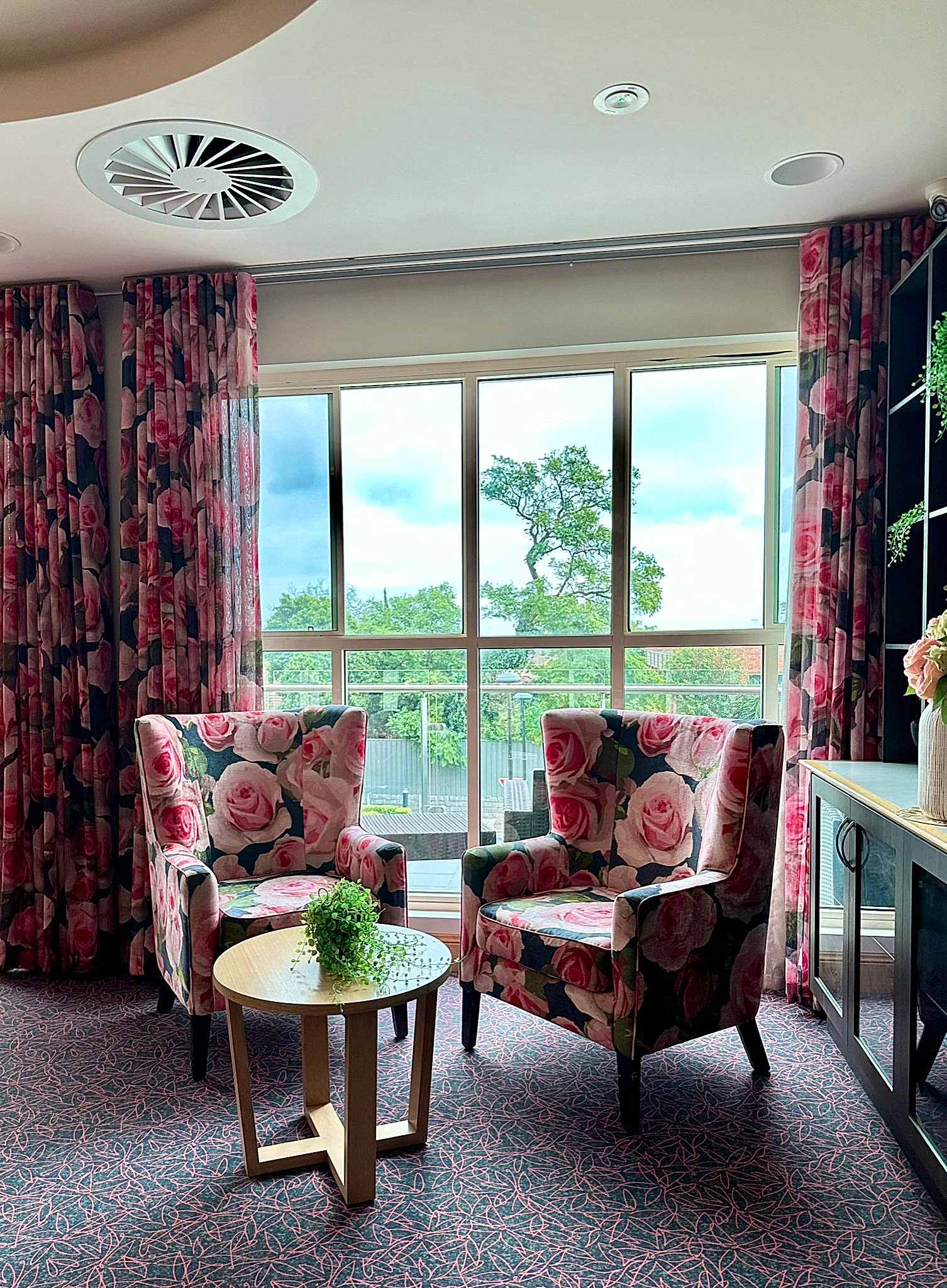 importance of design in an aged care setting. Custom upholstered chairs with coordinating curtains